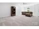 Spacious living room with carpet, a comfortable sofa, and a decorative bookcase against the wall at 5001 Oxfordshire Rd, Waxhaw, NC 28173