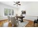 A home office featuring a desk, two chairs, a ceiling fan, and hardwood floors at 5001 Oxfordshire Rd, Waxhaw, NC 28173