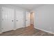 Bright bedroom with two closets, vinyl flooring, and painted with neutral colors at 501 Olmsted Park Pl # N, Charlotte, NC 28203