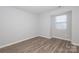 Bedroom features vinyl flooring, a window, and neutral paint at 501 Olmsted Park Pl # N, Charlotte, NC 28203