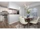 Chic dining area with modern lighting and views into the well-appointed kitchen at 501 Olmsted Park Pl # N, Charlotte, NC 28203