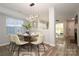 Dining room with seating for six, stylish light fixture, and open concept living space at 501 Olmsted Park Pl # N, Charlotte, NC 28203