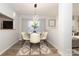 Well-lit dining area featuring a modern light fixture, seating for six, and neutral decor at 501 Olmsted Park Pl # N, Charlotte, NC 28203
