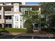 Charming blue condo with balconies, complemented by mature trees and professional landscaping at 501 Olmsted Park Pl # N, Charlotte, NC 28203
