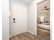 Inviting foyer with hardwood floors leading to a bedroom, featuring a white door at 501 Olmsted Park Pl # N, Charlotte, NC 28203
