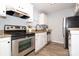 Kitchen featuring granite counters, stainless steel appliances, and white cabinets at 501 Olmsted Park Pl # N, Charlotte, NC 28203