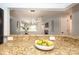 Open kitchen with granite counters overlooking a dining area with modern lighting at 501 Olmsted Park Pl # N, Charlotte, NC 28203