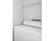 This laundry room has a washer and dryer and a wire rack for extra storage space at 501 Olmsted Park Pl # N, Charlotte, NC 28203