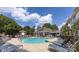 Community pool surrounded by lounge chairs and lush landscaping at 501 Olmsted Park Pl # N, Charlotte, NC 28203
