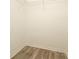 An empty walk-in closet with laminate wood flooring and wire shelving at 501 Olmsted Park Pl # N, Charlotte, NC 28203