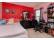 Vibrant bedroom featuring a bed, black dresser, keyboard and bookshelves at 5127 Fernhill Dr, Charlotte, NC 28217