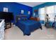 Large bedroom with an electric blue accent wall and musical decor at 5127 Fernhill Dr, Charlotte, NC 28217