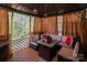 Cozy gazebo with comfortable seating, ambient lighting, and relaxing backyard view at 5127 Fernhill Dr, Charlotte, NC 28217