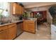 Well-lit kitchen offering stainless steel appliances, natural wood cabinetry, and a view into the dining room at 5127 Fernhill Dr, Charlotte, NC 28217