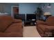 Cozy living room features comfortable seating and dual entertainment centers at 5127 Fernhill Dr, Charlotte, NC 28217