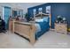 The primary suite boasts a striking blue accent wall and ornate furnishings at 5127 Fernhill Dr, Charlotte, NC 28217