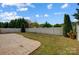 Spacious backyard featuring a well-maintained lawn, stamped concrete patio, and a privacy fence for outdoor living at 5713 Falkirk Ln, Matthews, NC 28104