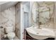Bathroom featuring marble-like tile in shower, toilet, and sink; oval mirror and modern fixtures at 5713 Falkirk Ln, Matthews, NC 28104