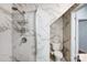 Bathroom features marble-like tile in shower, toilet, and storage nook; bright and modern at 5713 Falkirk Ln, Matthews, NC 28104