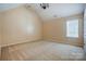 Bedroom with vaulted ceilings and a window, offering a comfortable living space at 5713 Falkirk Ln, Matthews, NC 28104