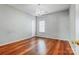 Bright bedroom with hardwood floors and a chandelier; neutral wall color at 5713 Falkirk Ln, Matthews, NC 28104