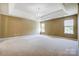 Spacious bedroom with beige walls, carpet, ceiling fan, and natural light from windows at 5713 Falkirk Ln, Matthews, NC 28104