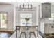 Bright dining area with large windows, a modern light fixture, and stylish seating at 5713 Falkirk Ln, Matthews, NC 28104
