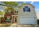 Charming two-story home with brick and vinyl siding, attached garage, and well-maintained front yard at 5713 Falkirk Ln, Matthews, NC 28104