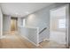 Upstairs hallway with carpet; neutral wall color and view to bedroom at 5713 Falkirk Ln, Matthews, NC 28104