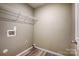 Laundry room with shelving and sleek wood-look flooring, providing a modern and functional space at 5713 Falkirk Ln, Matthews, NC 28104