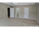 Spacious main bedroom featuring neutral colors, a tray ceiling, and dual closets and entry doors at 5713 Falkirk Ln, Matthews, NC 28104