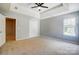 Bedroom featuring a ceiling fan, tray ceiling, closet, and window, offering a comfortable living space at 5713 Falkirk Ln, Matthews, NC 28104