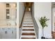 View of staircase with hardwood steps and white risers, adjacent to kitchen cabinets at 5713 Falkirk Ln, Matthews, NC 28104