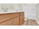 Bathroom with double vanity, wood cabinets, white countertop, mirror, and tub at 5850 Strathmore Ct, Charlotte, NC 28215
