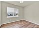 Cozy bedroom with modern window shades and sleek hardwood floors at 5850 Strathmore Ct, Charlotte, NC 28215