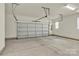 Garage with a large garage door, concrete flooring, and natural light at 5850 Strathmore Ct, Charlotte, NC 28215