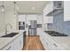 Well-lit kitchen showcasing modern appliances, gas range, ample storage, and countertop seating at 5850 Strathmore Ct, Charlotte, NC 28215