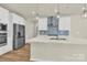 Modern kitchen features white cabinetry, stainless steel appliances, and an island with countertop seating at 5850 Strathmore Ct, Charlotte, NC 28215