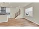 Living room featuring stairs, natural light and hardwood floors throughout at 5850 Strathmore Ct, Charlotte, NC 28215