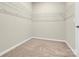 Walk-in closet with neutral walls, neutral carpet, and wire shelving at 5850 Strathmore Ct, Charlotte, NC 28215