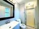 Bathroom featuring a framed mirror, vanity, toilet, and shower with glass doors at 6430 Farmingdale Dr, Charlotte, NC 28212