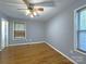 Bedroom showcasing hardwood floors, modern windows, neutral paint, and new trim work at 6430 Farmingdale Dr, Charlotte, NC 28212
