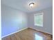 Bright bedroom featuring a window and hardwood floors at 6430 Farmingdale Dr, Charlotte, NC 28212