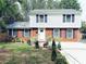 Charming two-story home featuring a classic brick facade and manicured front yard landscaping at 6430 Farmingdale Dr, Charlotte, NC 28212