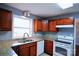 Open kitchen featuring granite counters and wood cabinetry at 6430 Farmingdale Dr, Charlotte, NC 28212