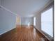 Large living room features hardwood floors and natural light from two large windows at 6430 Farmingdale Dr, Charlotte, NC 28212