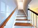 Staircase leading up to the second floor with hardwood steps and white risers at 6430 Farmingdale Dr, Charlotte, NC 28212