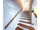 Staircase with hardwood steps and handrail at 6430 Farmingdale Dr, Charlotte, NC 28212