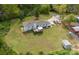 Aerial view of a sprawling backyard featuring a deck, shed, and ample green space at 6599 Mcintosh Rd, Stanley, NC 28164