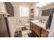 This bathroom features hardwood floors, light gray walls, a toilet, and a wooden sink at 6599 Mcintosh Rd, Stanley, NC 28164